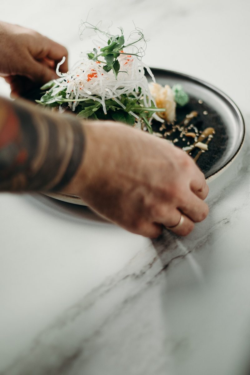 A green low-carb salad arranged in a shallow bowl.